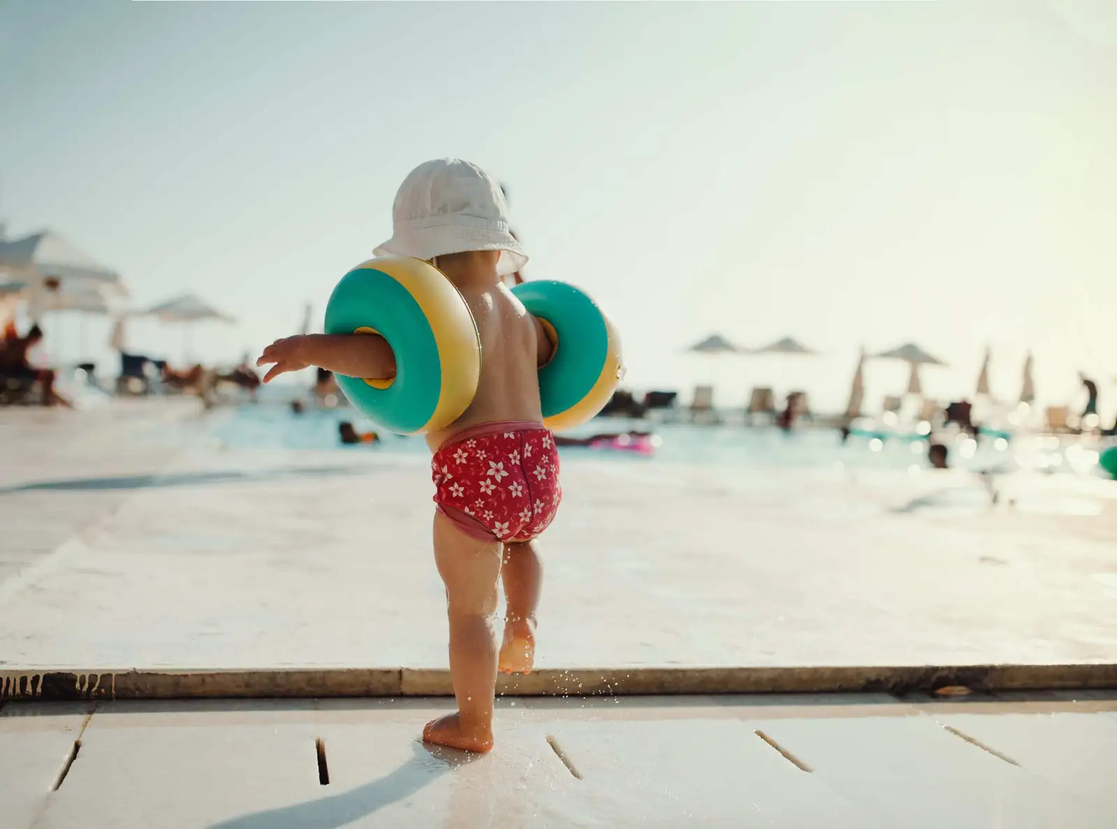 A child swimming safely in a supervised backyard pool