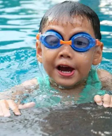 A pool safety inspector checking a pool gate for compliance